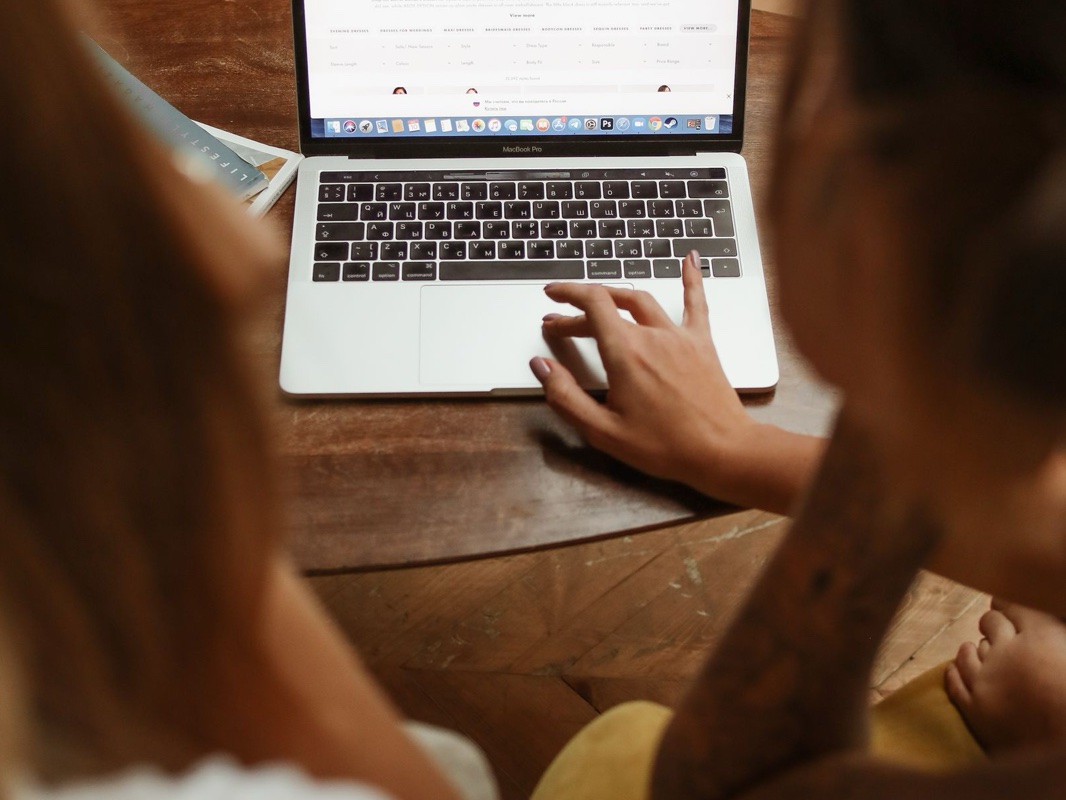 Two people comparing products while shopping online