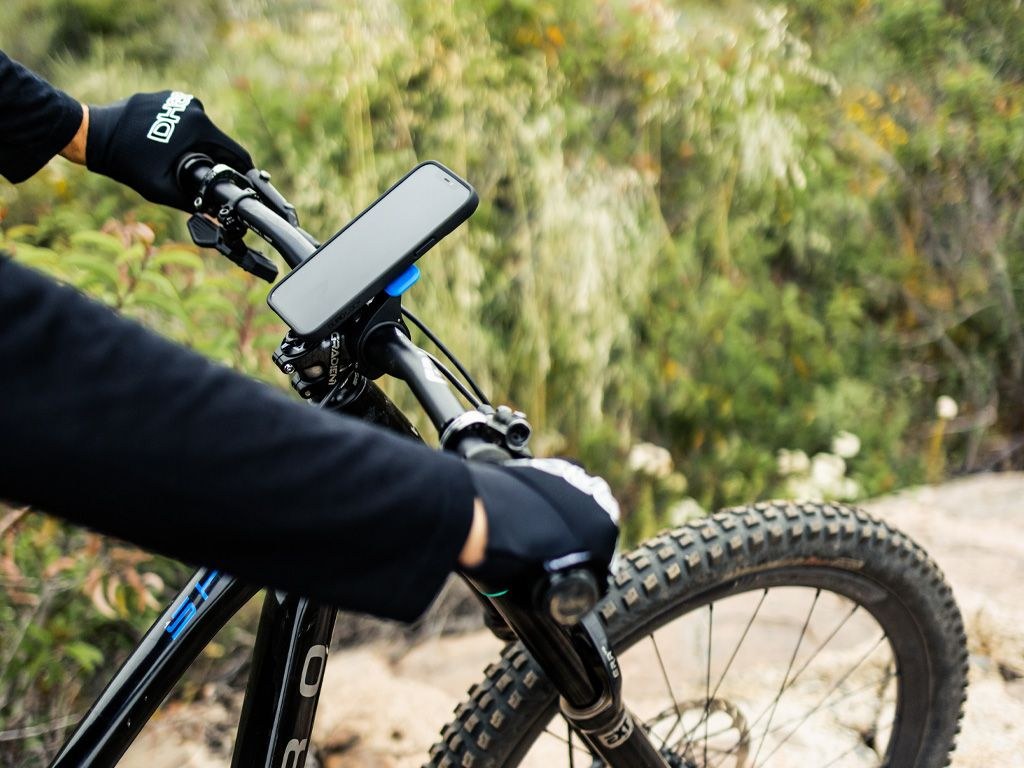 Quad Lock phone mount holding a phone on a mountain bike handlebar